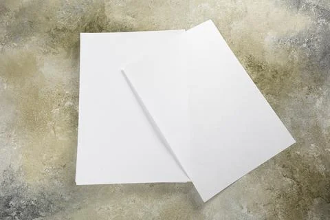 Stack of white business card sheet of paper a4 stack on grunge table. Stock Photos