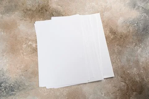 Stack of white business card sheet of paper a4 stack on grunge table. Stock Photos