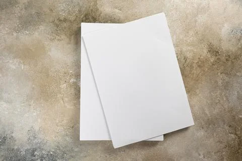 Stack of white business card sheet of paper a4 stack on grunge table. Stock Photos