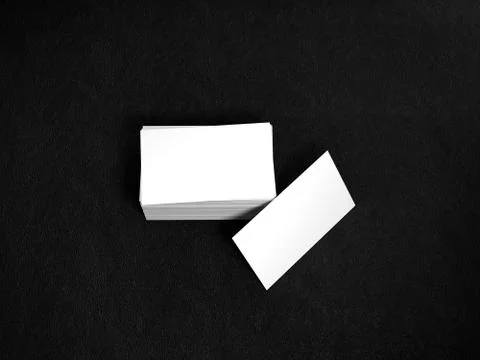 Stack of white business cards. Namecards mockup template on black leather Illustrazione stock