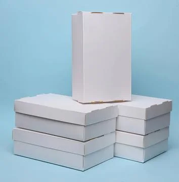 Stack of white cardboard boxes on blue background Stock Photos