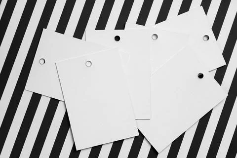 Stack of white cardboard label tags for clothes with little holes in top part of Stock Photos