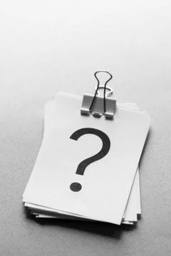 Stack of white cards printed with question marks Stock Photos