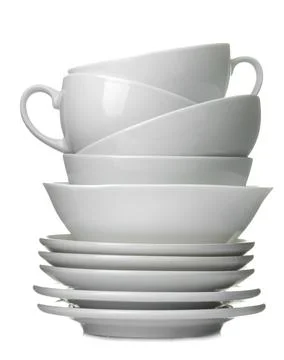 A stack of white ceramic dishes, plates, saucers, cups on a white isolated ba Stock Photos