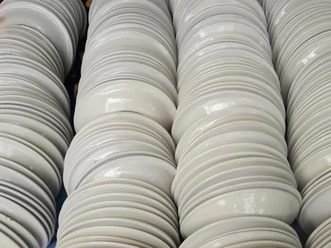 Stack of White Ceramic Plates in Factory or Kitchen Storage Stock Photos