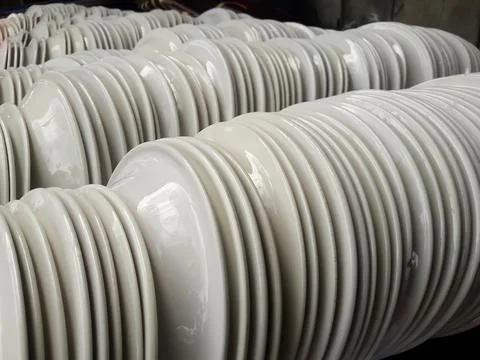 Stack of White Ceramic Plates in Factory or Kitchen Storage Stock Photos