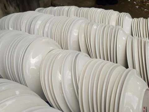 Stack of White Ceramic Plates in Factory or Kitchen Storage Stock Photos