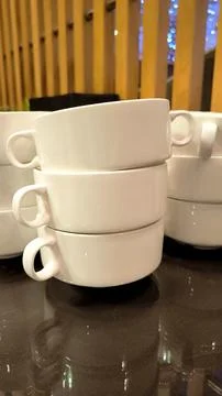 Stack of white ceramic soup bowls with handles. Foto stock