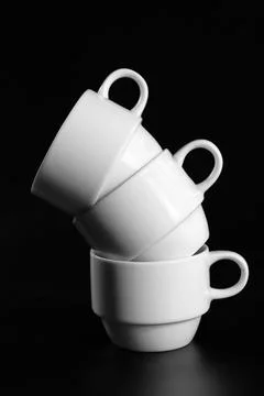 Stack of white coffee cups on black background close up Stock Photos