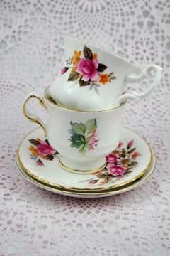 Stack of white coffee cups with floral paintings Stock Photos