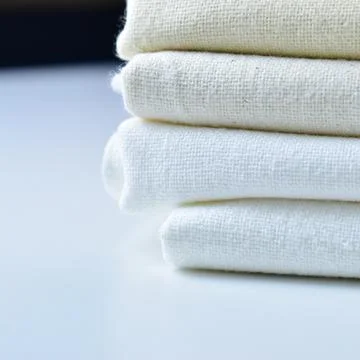 Stack of white cotton clothes, pile of clothing on white background Foto stock