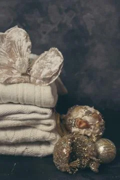 Stack of white cozy knitted sweaters on dark festive background Stock-Fotos