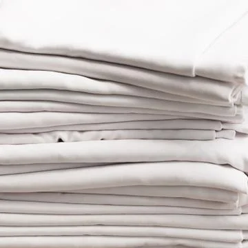 Stack of white folded cotton tablecloths Stock Photos