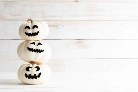 Stack of white ghost pumpkin on white wooden background. halloween concept. Stock Photos