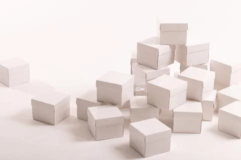 Stack of white gift boxes and copy space over white background Stock Photos