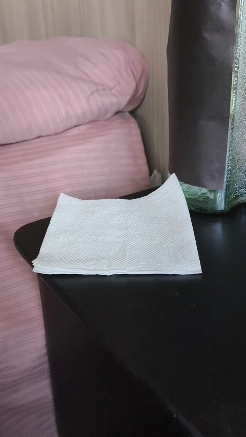 A stack of white handkerchiefs, napkins on the bedside table. The concept of Stock Footage 318132822