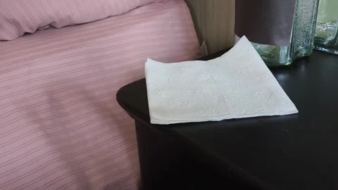 A stack of white handkerchiefs, napkins on the bedside table. The concept of Stock Footage 318132906