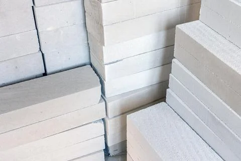 Stack of white lightweight concrete block, used for construction wall. Stock Photos