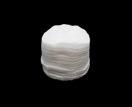 A stack of white natural sponges for skin care isolated on a black background Stock Photos