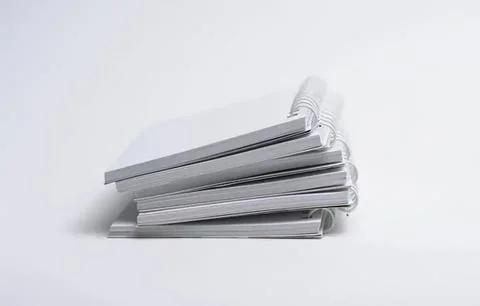 Stack of white notebooks or journals on a plain background Stock Photos