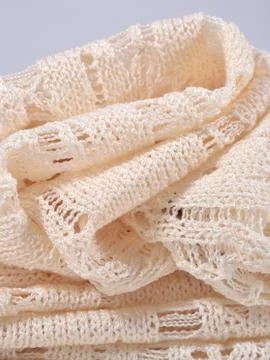 Stack of white openwork knitted fabric Stock Photos