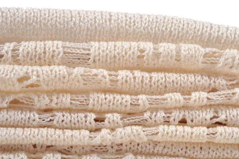 Stack of white openwork knitted fabric Stock Photos