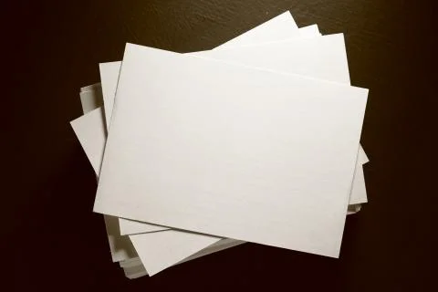 Stack of white paper cards on black 写真素材