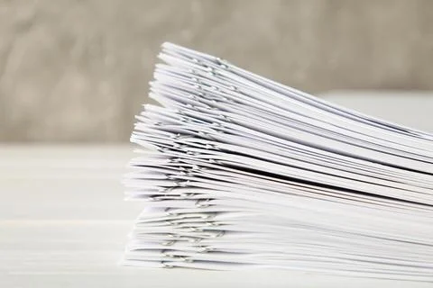 Stack of white paper with clips on grey background Stock Photos