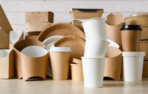 A stack of white paper cups on the background of disposable tableware 스톡 사진