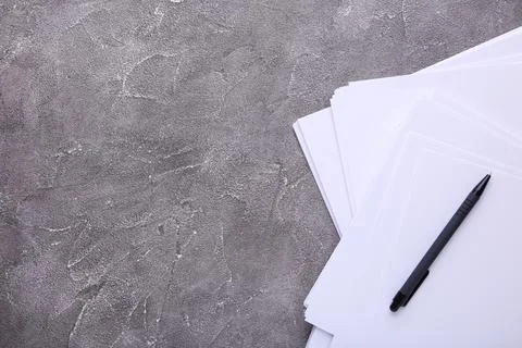 Stack white paper with pen on grey concrete background with Clipping Path Stock Photos