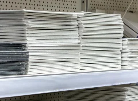 A stack of white paper is on a shelf 스톡 사진