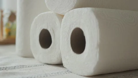Stack of white paper towel rolls on a textured surface indoors closeup. Stock Footage 332041325