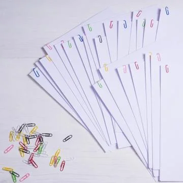 Stack of white papers with paper clips on office table Stock Photos