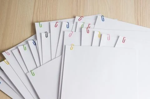 Stack of white papers with paper clips on office table Stock Photos