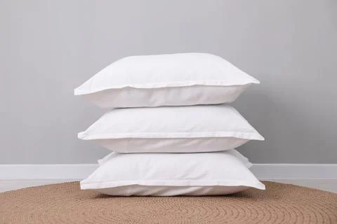 Stack of white pillows on floor indoors Stockfoto's
