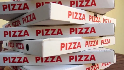 Stack of white pizza boxes with red letters Stock Footage 143496744