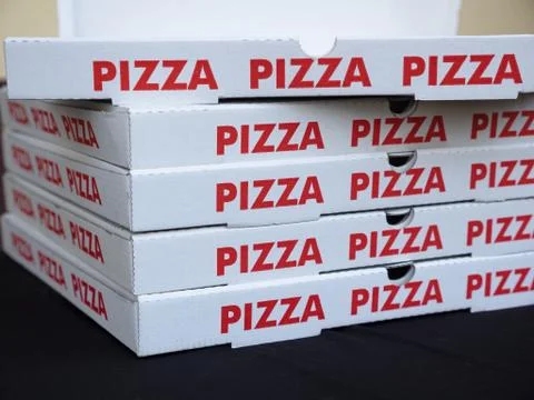Stack of white pizza boxes with red letters 写真素材