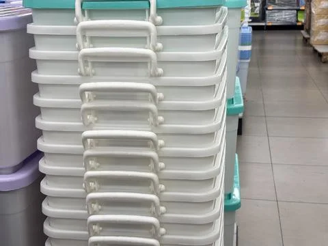 Stack of White Plastic Storage Containers with Handles in a Retail Store Aisle Stock Photos