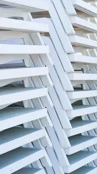 A stack of white plastic sun loungers or beach chairs Stock Photos