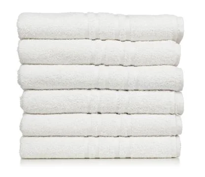 Stack of white plush hotel towels isolated on white background Stock Photos