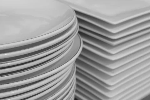 Stack of white porcelain crockery. Ceramic dishware pile Stock Photos
