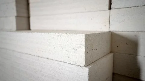 Stack of white porous construction blocks with focus on corner texture Stock Photos