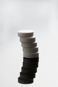 Stack of white round pills isolated on white background. Medical treatment Stock Photos