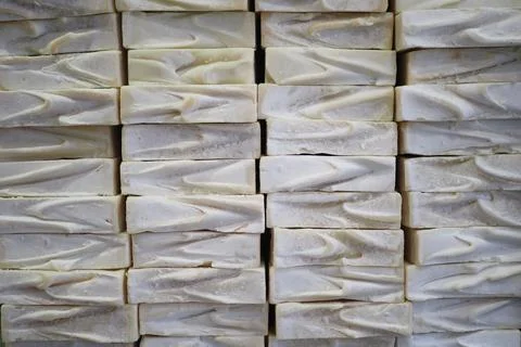A stack of white soaps with blue ribbons in a basket Stock Photos