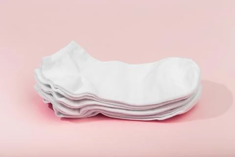 Stack of white socks on pink background - Imagr Stock Photos