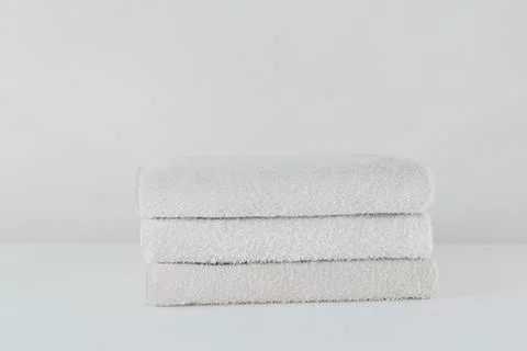 Stack of white soft towels isolated on white background Stock Photos