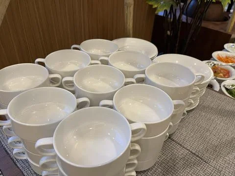 Stack of white soup bowls in a restaurant. Stock Photos
