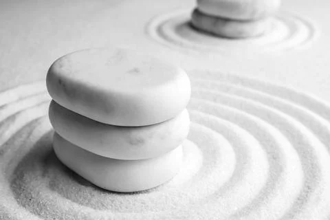 Stack of white stones on sand with pattern, closeup. Zen, meditation, harmony Stock Photos