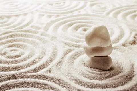 Stack of white stones on sand with pattern, space for text. Zen, meditation.. Stock Photos