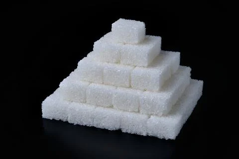 Stack of white sugar cubes at black background 스톡 사진